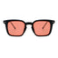 Sunglasses with black frame and red lenses on a white background.