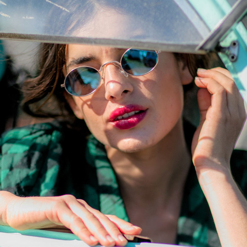 woman wear small teashade sunglasses with metal frame blue mirror lens SOLFUL Ibiza design