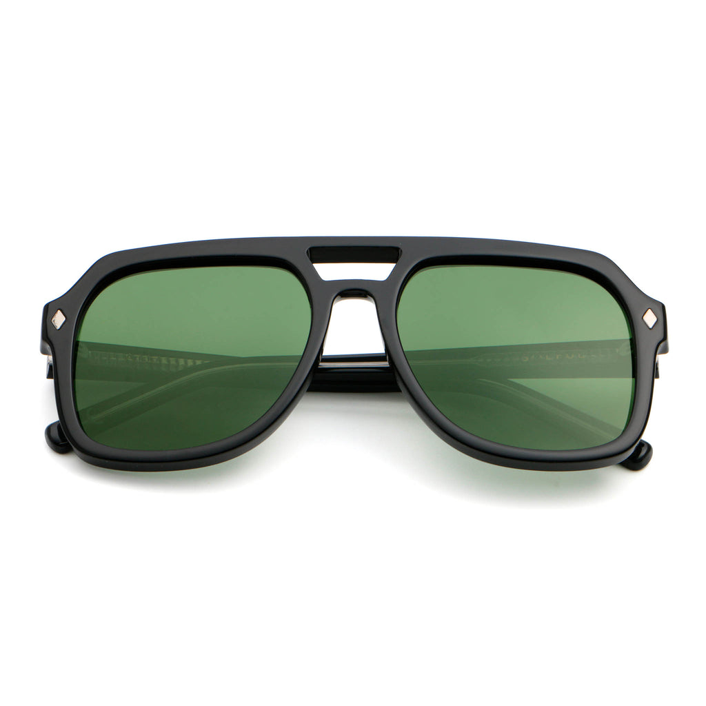 Black sunglasses with green lenses on a white background
