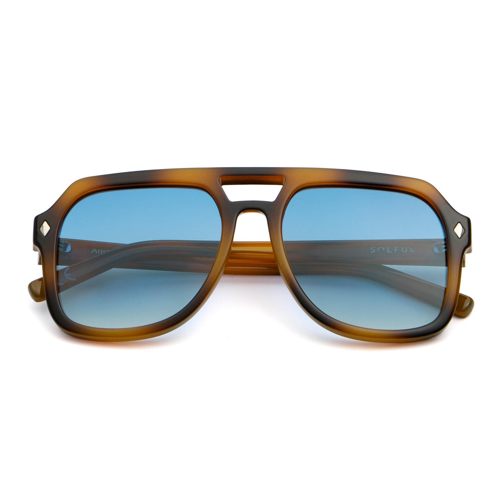 Sunglasses with tortoiseshell frame and blue lenses on a white background