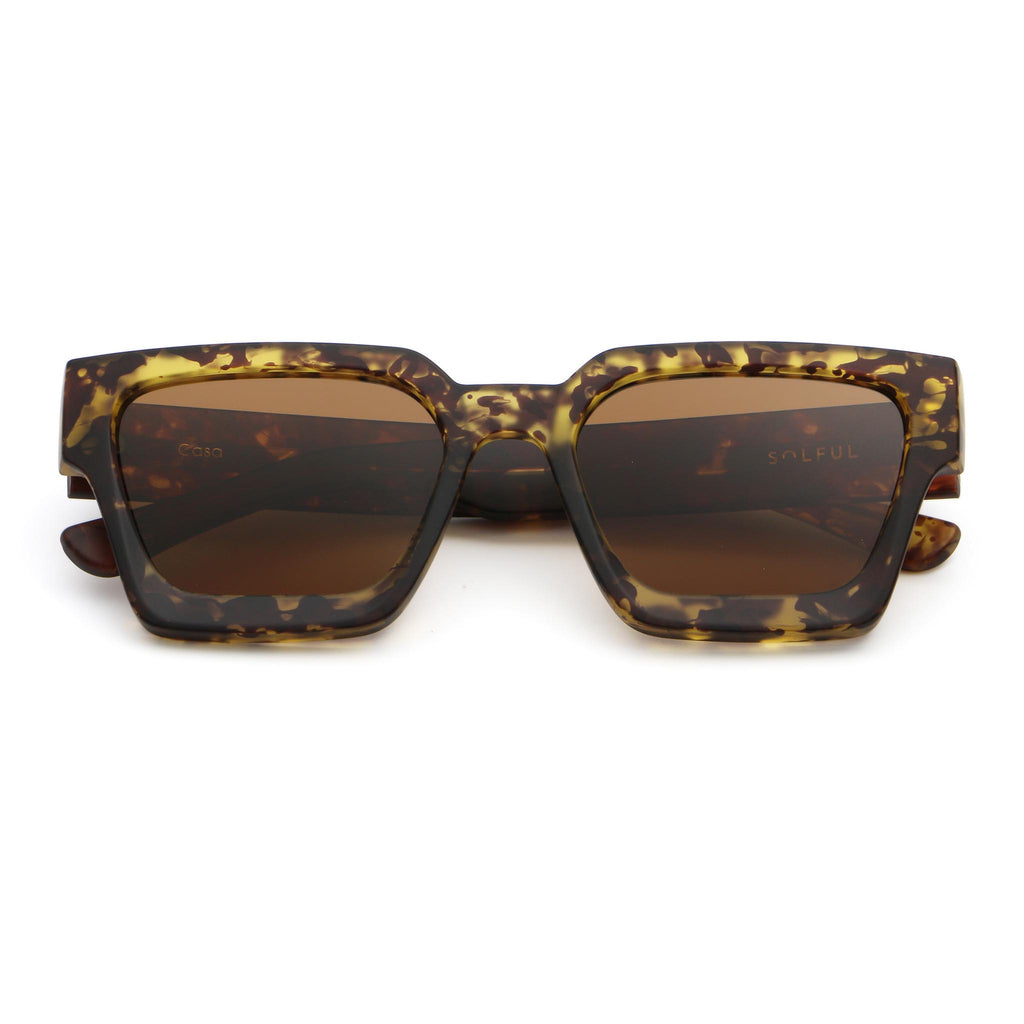 Sunglasses with tortoiseshell frame and brown lenses on a white background