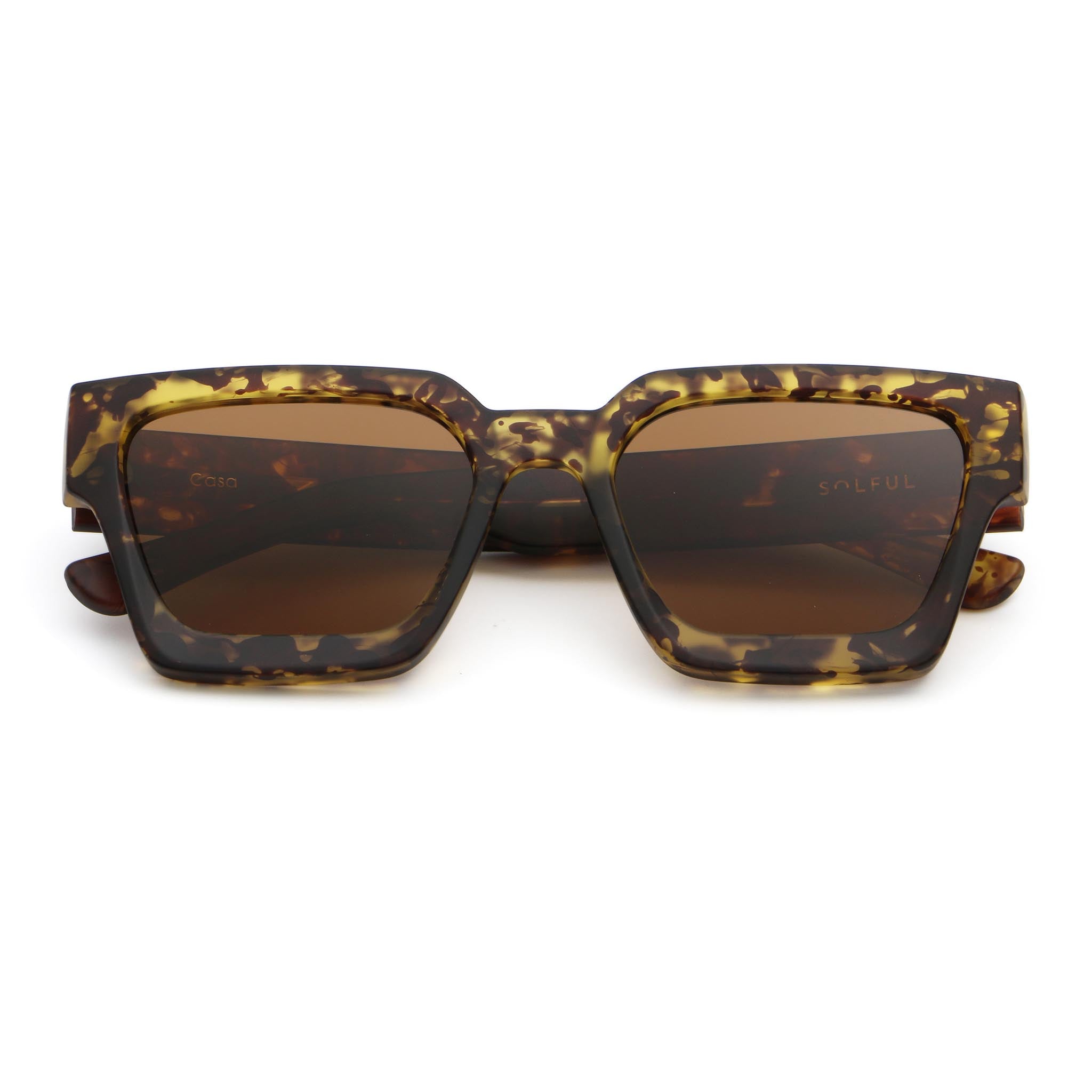 Sunglasses with tortoiseshell frame and brown lenses on a white background
