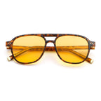 Sunglasses with tortoiseshell frame and yellow lenses on a white background