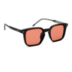 Sunglasses with black frame and red-tinted lenses on a white background