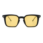 Black-framed sunglasses with yellow lenses on a white background