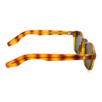 Sunglasses with tortoiseshell frame and dark lenses on a white background