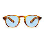 Sunglasses with tortoiseshell frame and blue lenses on a white background