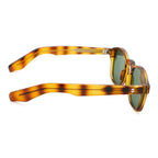 Sunglasses with tortoiseshell frame and green lenses on a white background