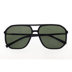 Black sunglasses with green lenses on a white background