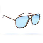 Sunglasses with tortoiseshell frame and blue lenses on a white background
