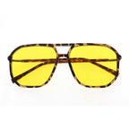 Sunglasses with yellow lenses and tortoiseshell frame on a white background